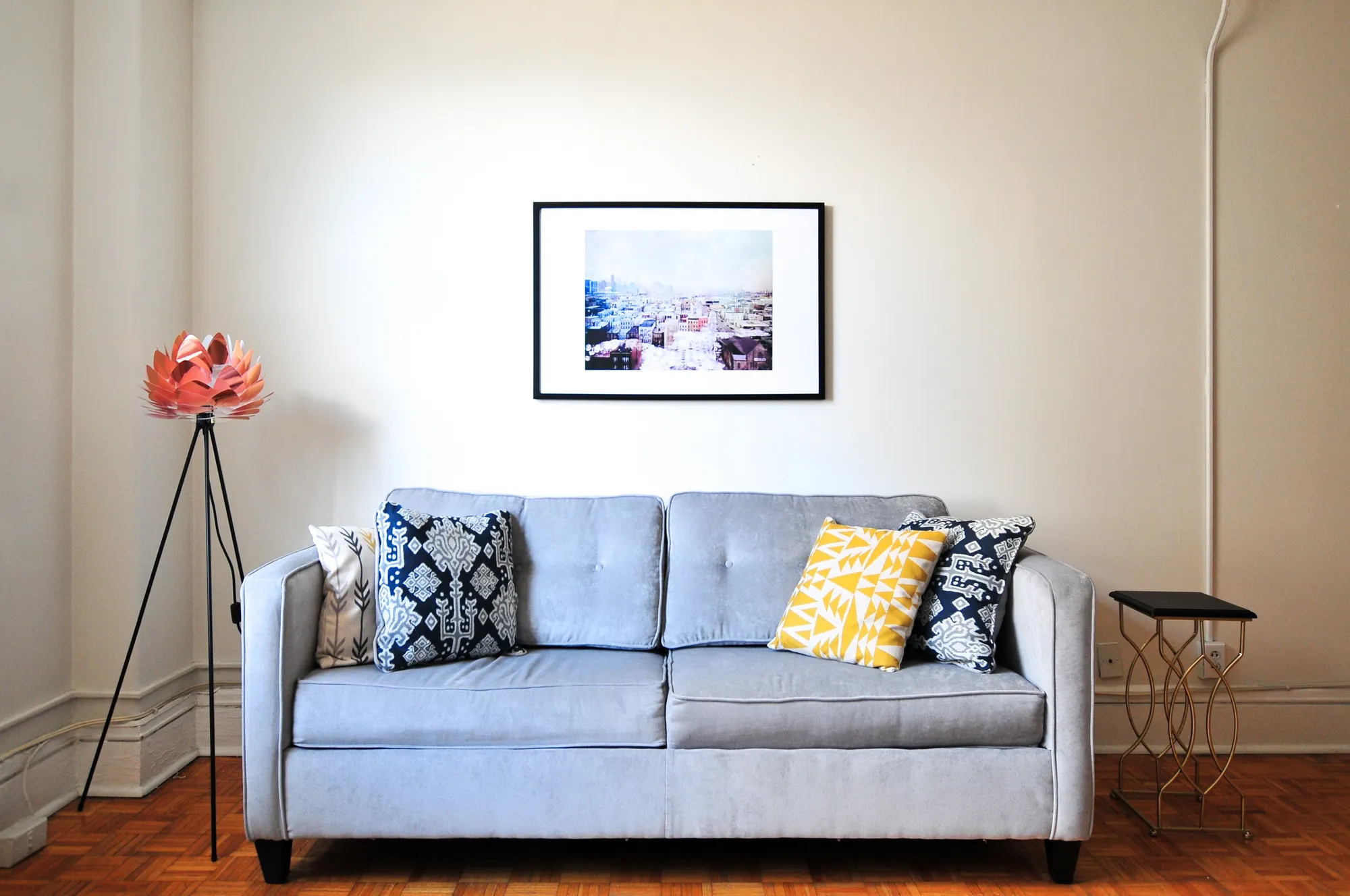 Living room with a full-height window beside an open stair